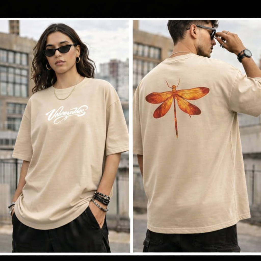 Model wearing a black oversized T-shirt with printed logo on the front and a dragonfly graphic on the back.”