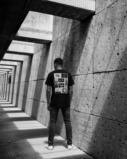 Person standing in a sunlit concrete corridor with geometric patterns.